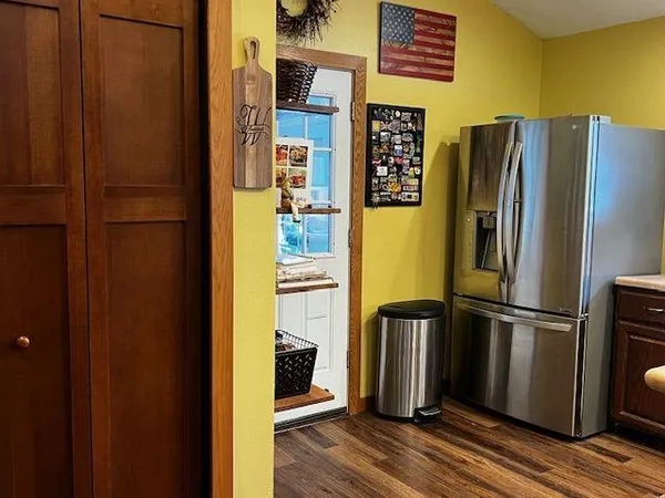 a view of a refrigerator in kitchen and wooden floor