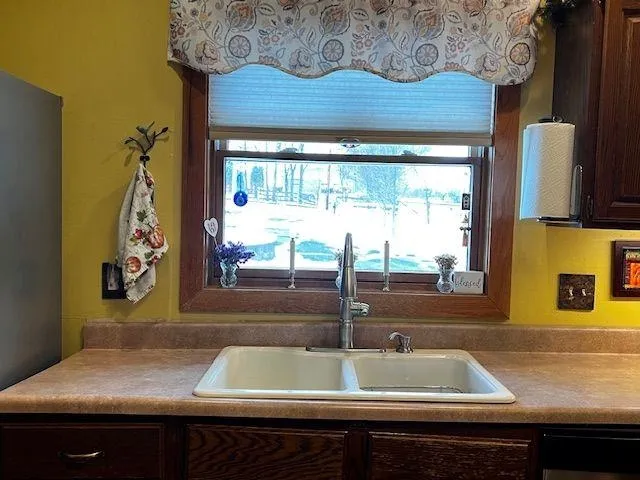 a view of a sink sitting next to a window
