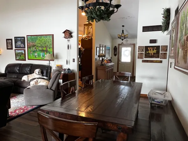 a view of a dining room with furniture and wooden floor