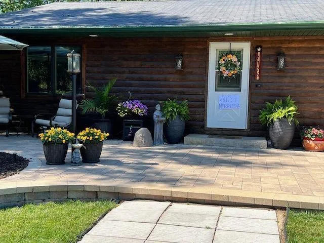 a view of a house with potted plants