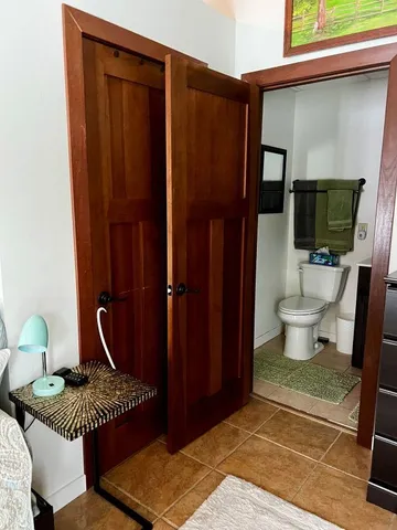 a bathroom with a toilet a sink and mirror