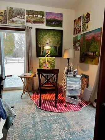 a living room with furniture a flat screen tv and a floor to ceiling window