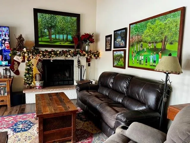 a living room with furniture a window and a flat screen tv