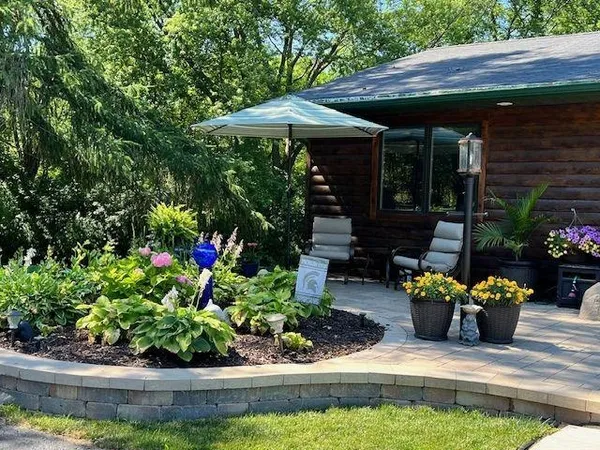 a front view of a house with a yard patio and swimming pool