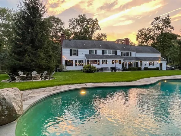 a view of a house with swimming pool and yard