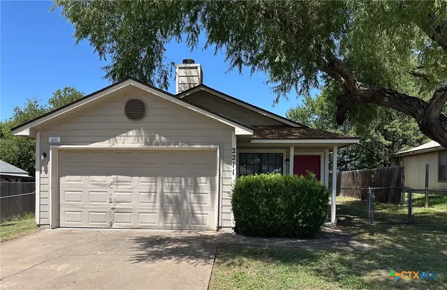 a kitchen with granite countertop a sink stove and cabinets