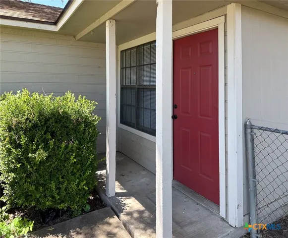 a kitchen with granite countertop a sink stove and cabinets