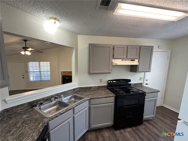 a view of a kitchen from the hallway