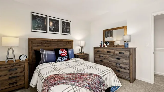 a bedroom with a bed and a dresser