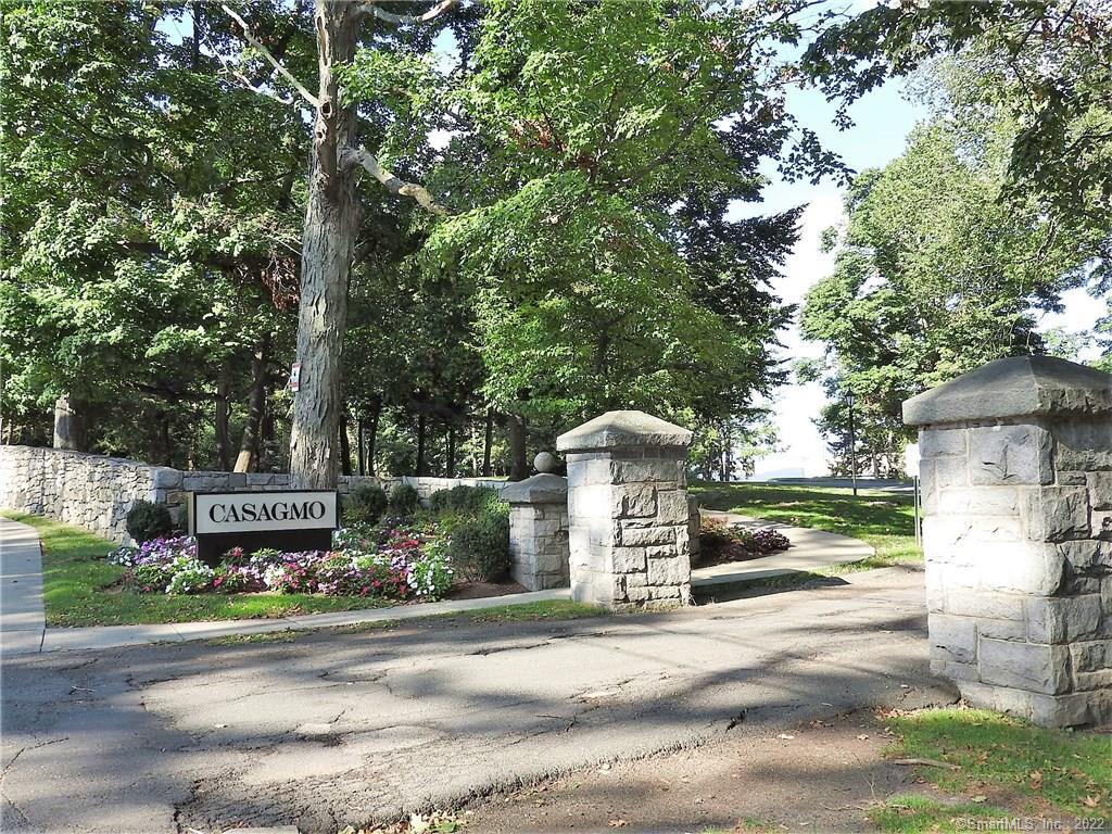 a sign board with buildings in the background