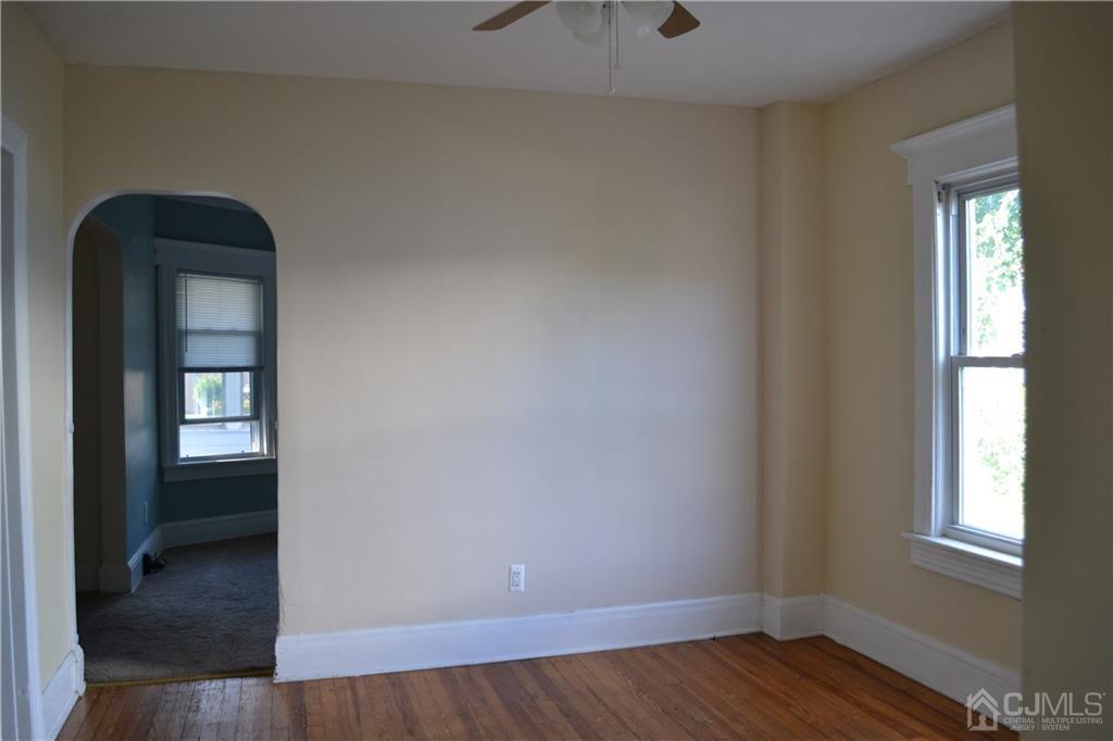 635 Front Street Dunellen, NJ 08812 - Photo 12 of 18 a view of an empty room with wooden floor and a window
