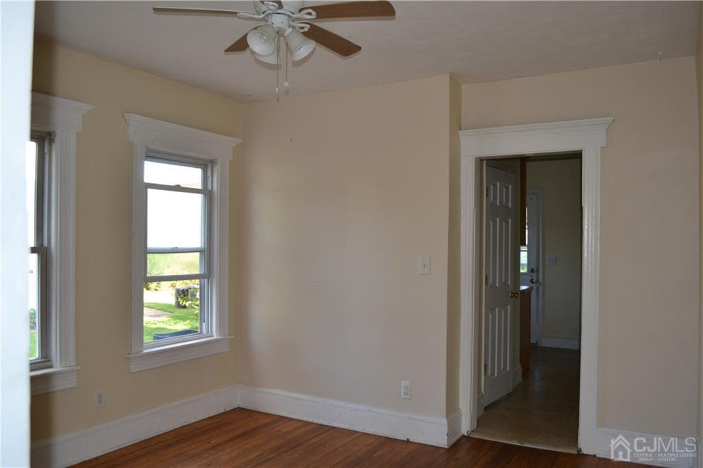 635 Front Street Dunellen, NJ 08812 - Photo 13 of 18 a view of an empty room with wooden floor and a window