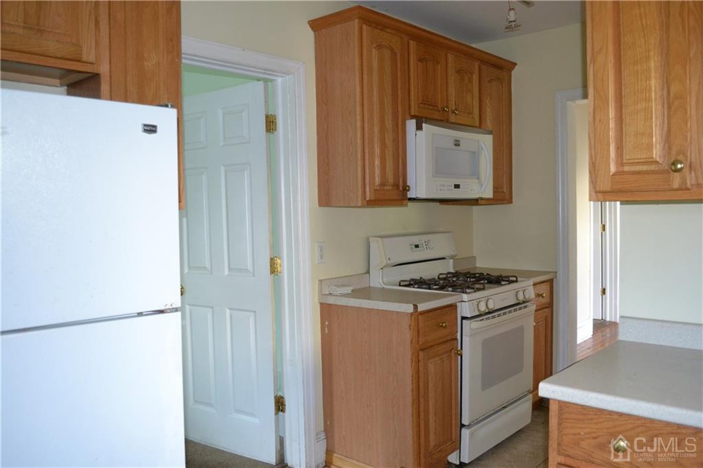 635 Front Street Dunellen, NJ 08812 - Photo 7 of 18 a kitchen with a stove and a refrigerator