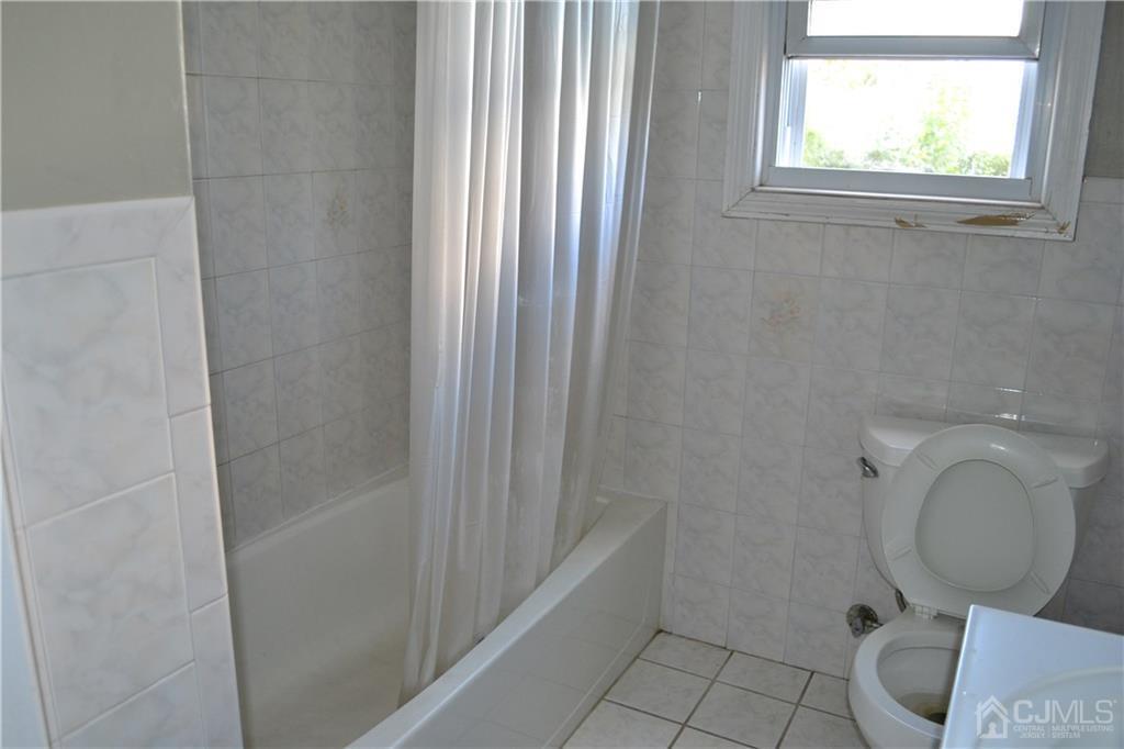 635 Front Street Dunellen, NJ 08812 - Photo 9 of 18 a bathroom with a toilet and a sink