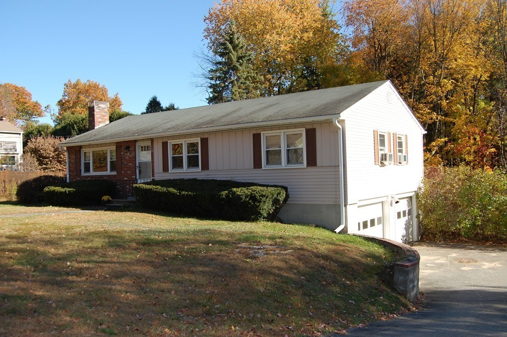a view of a white house with a yard