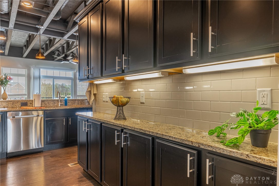 407 Brownstone Row Springboro, OH 45066 - Photo 20 of 54 This modern kitchen features rich cabinetry, sleek countertops, and practical appliances, perfect for daily living.
