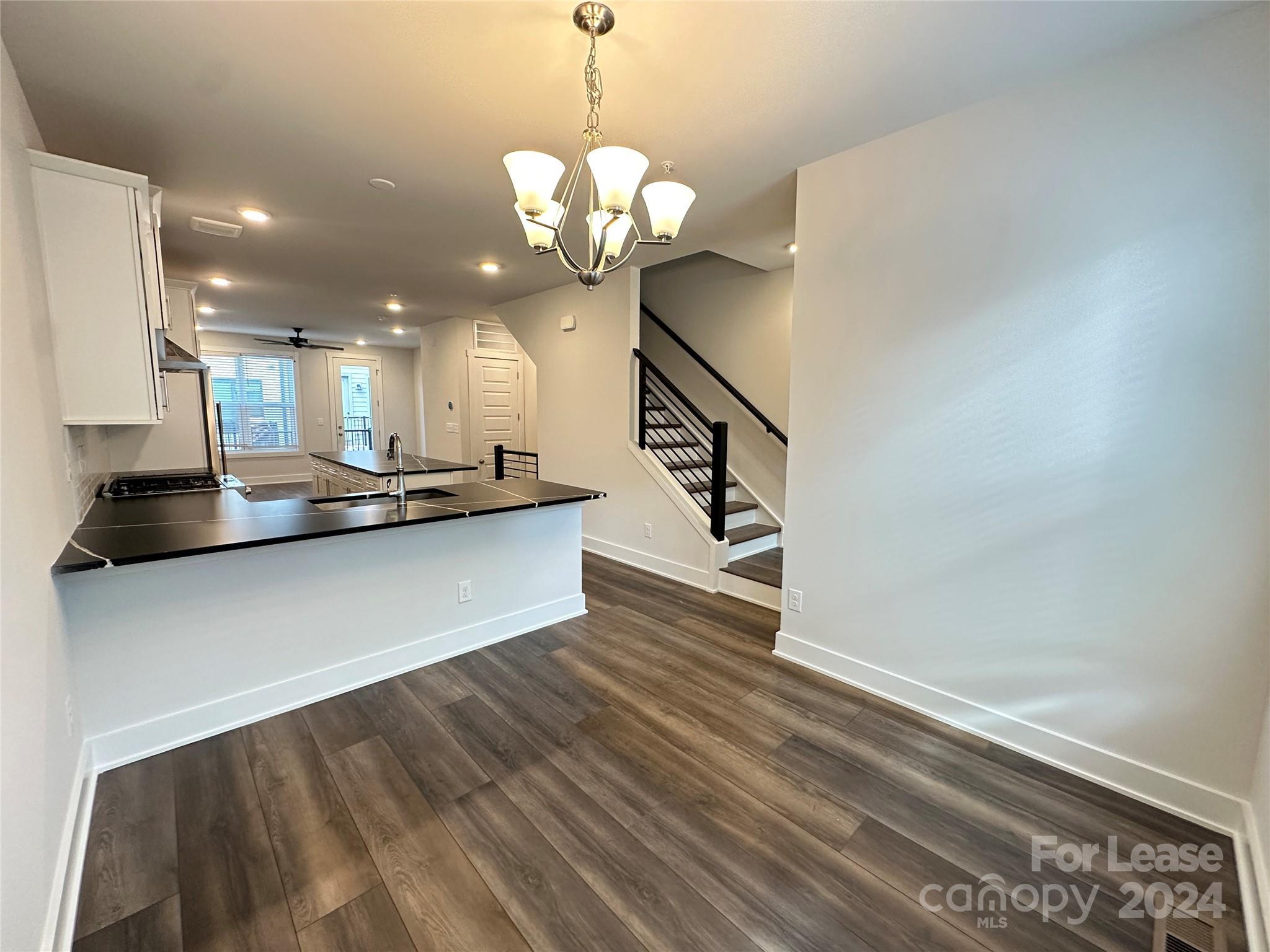 2124 Terwilliger Trail Charlotte, NC 28203 - Photo 11 of 36 a view of a kitchen with a sink stainless steel appliances and a chandelier