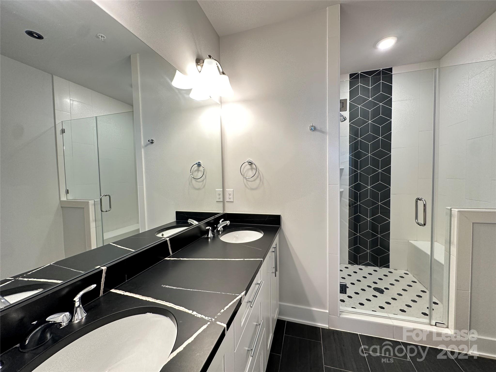 2124 Terwilliger Trail Charlotte, NC 28203 - Photo 17 of 36 a bathroom with a sink a toilet and shower