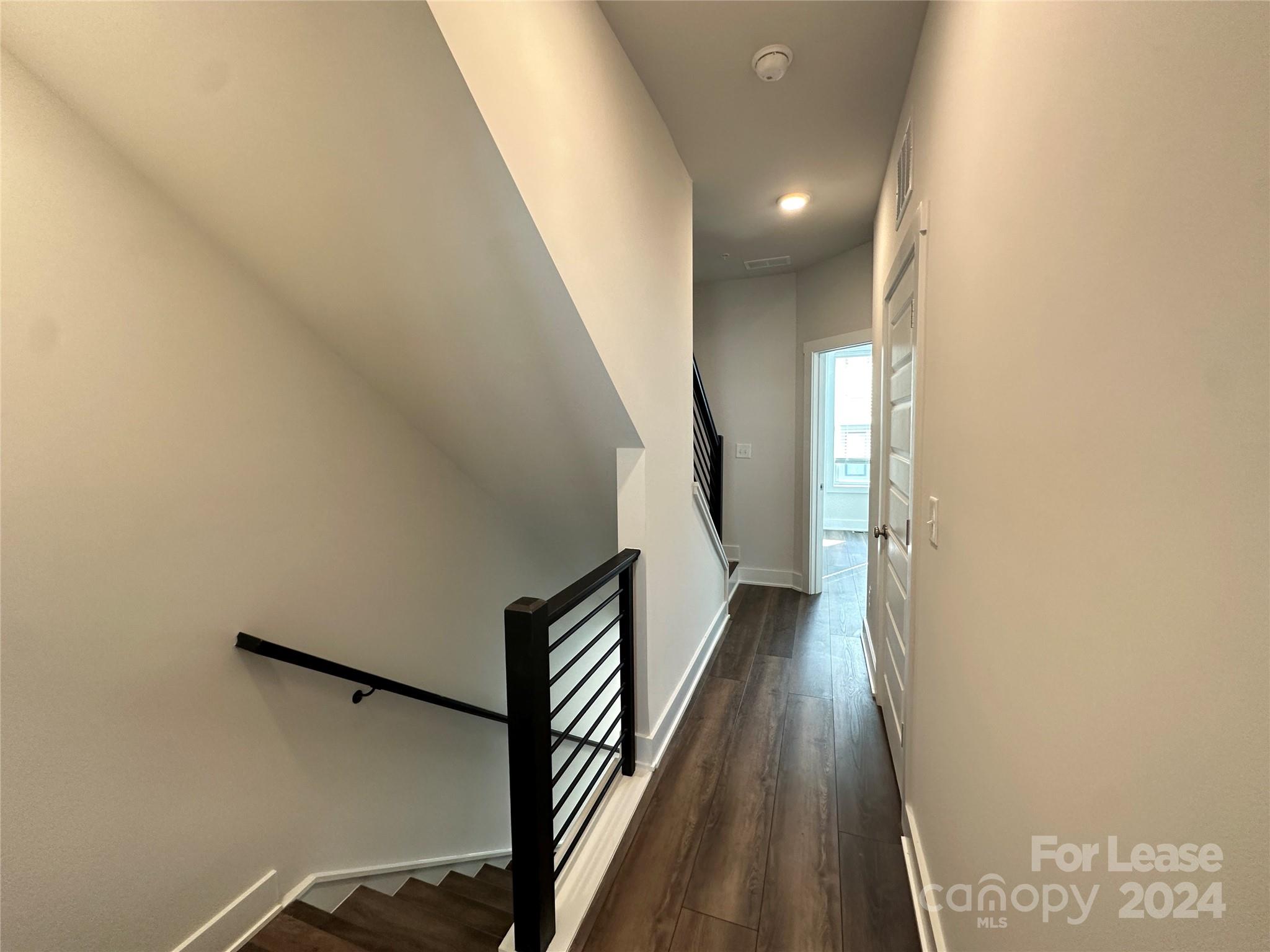 2124 Terwilliger Trail Charlotte, NC 28203 - Photo 19 of 36 a view of a hallway with wooden floor and staircase