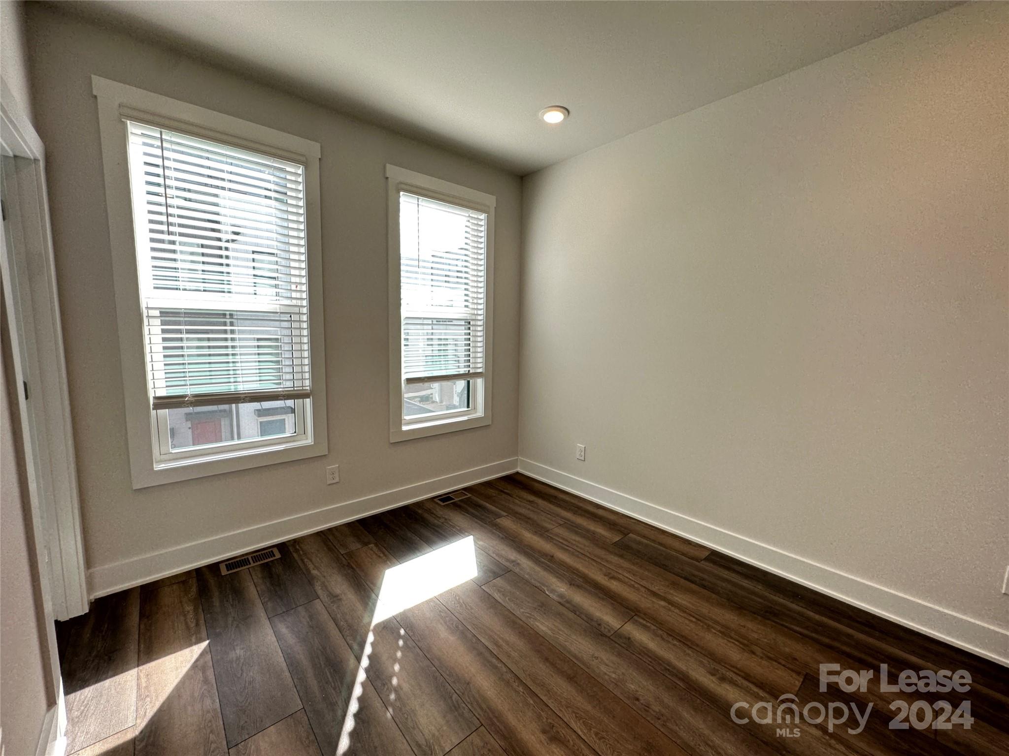 2124 Terwilliger Trail Charlotte, NC 28203 - Photo 21 of 36 a view of an empty room with wooden floor and a window