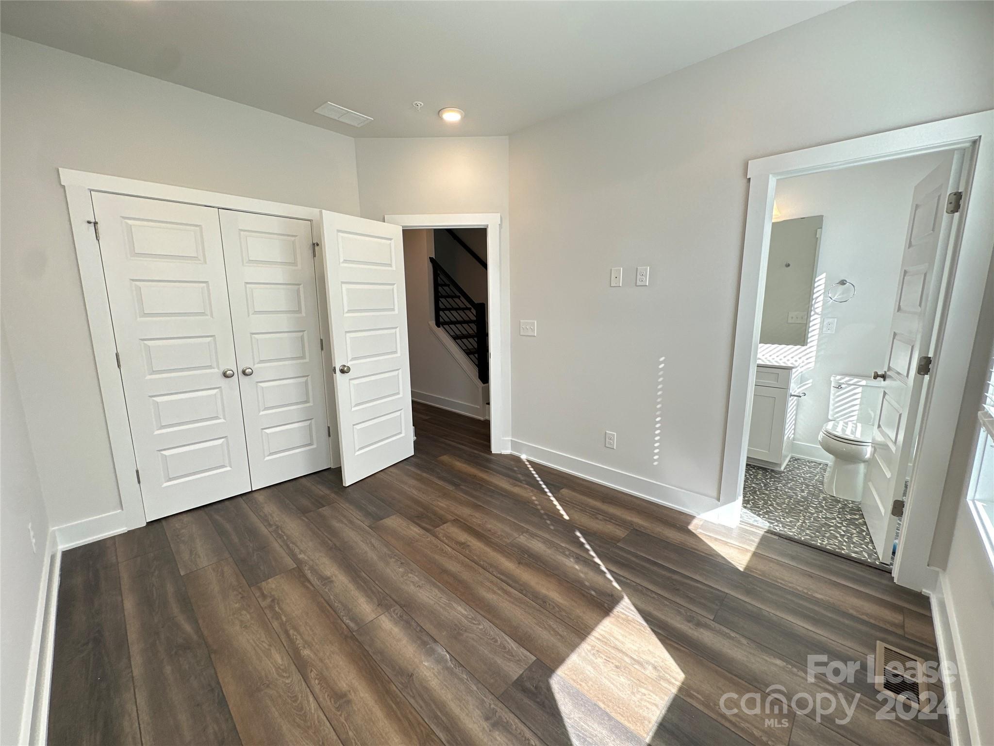 2124 Terwilliger Trail Charlotte, NC 28203 - Photo 24 of 36 an empty room with wooden floor and white walls