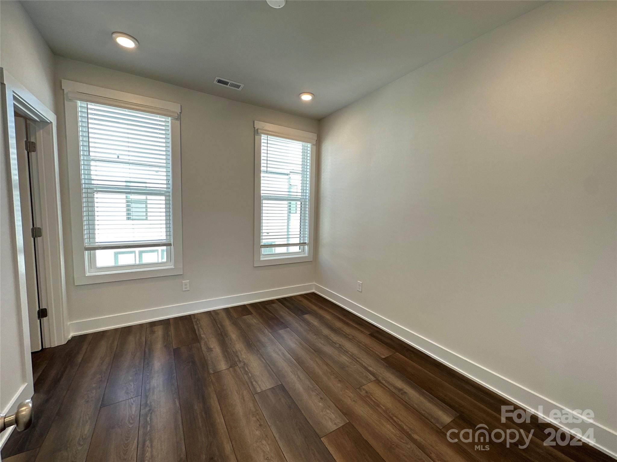 2124 Terwilliger Trail Charlotte, NC 28203 - Photo 29 of 36 an empty room with wooden floor and windows
