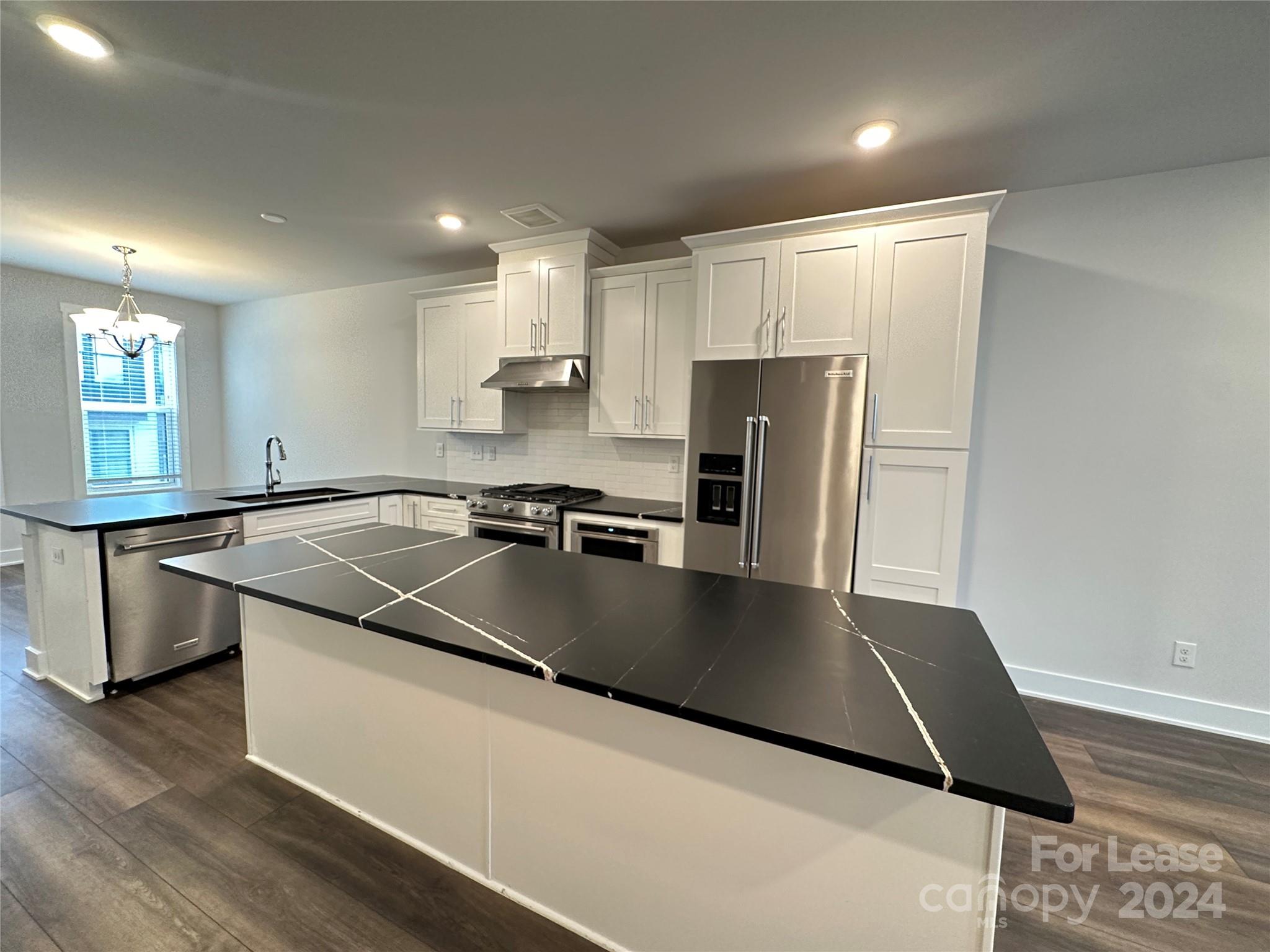 2124 Terwilliger Trail Charlotte, NC 28203 - Photo 4 of 36 a kitchen with stainless steel appliances granite countertop a sink a stove and a refrigerator