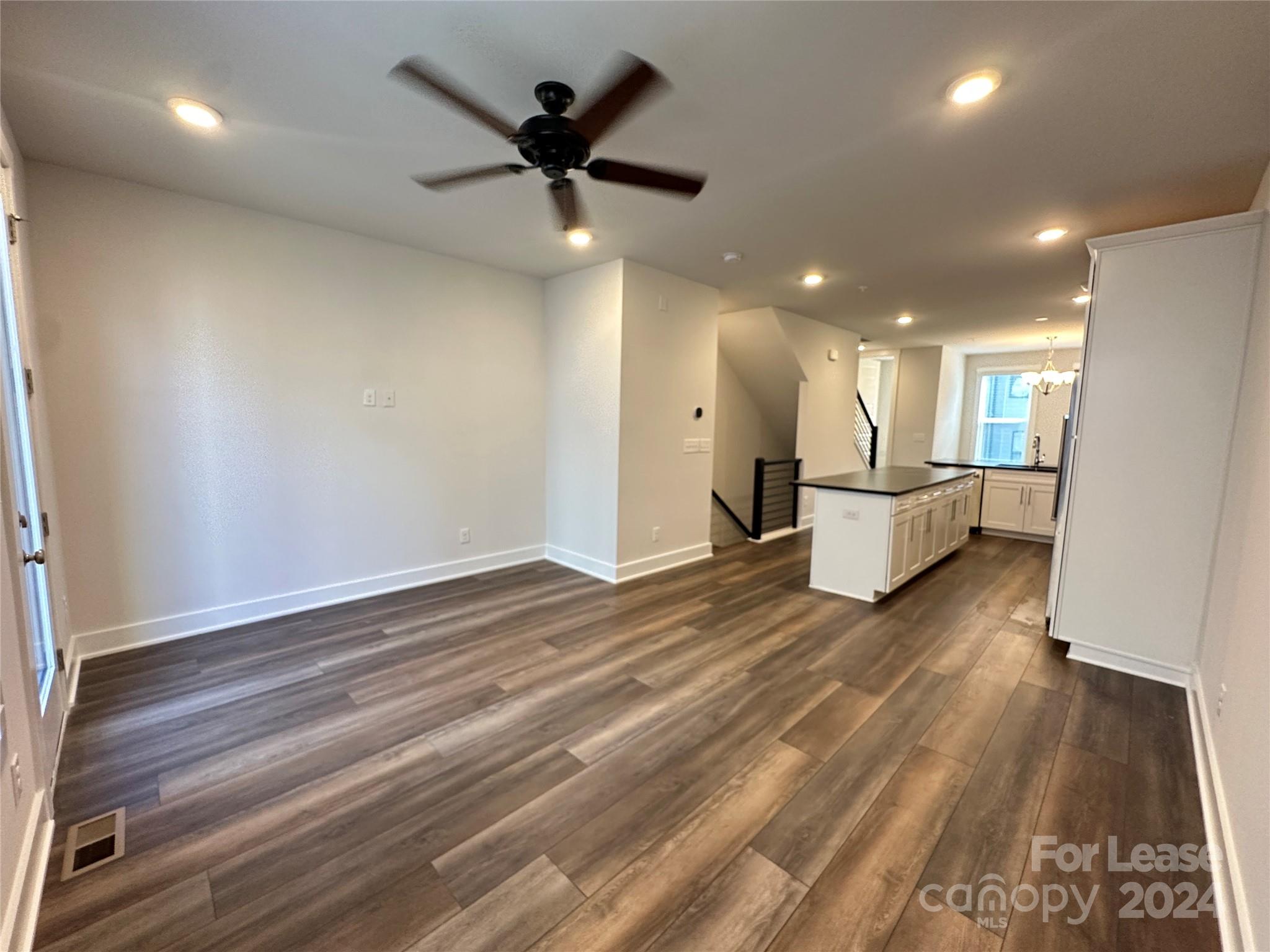 2124 Terwilliger Trail Charlotte, NC 28203 - Photo 6 of 36 an empty room with wooden floor and a ceiling fan
