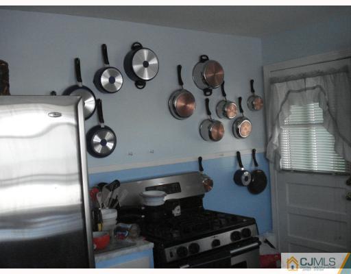 376 Old Post Road Edison, NJ 08817 - Photo 3 of 6 a kitchen with a stove and a wooden floor