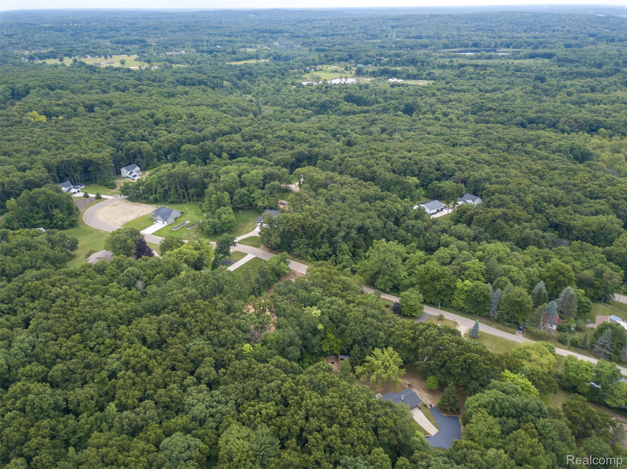 16085 Catalpa Ridge Holly, MI 48442 - Photo 35 of 40 Expansive wooded landscape with scattered residential properties