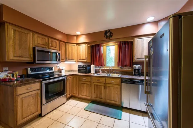 a kitchen with a sink stove and microwave