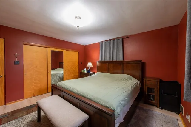 a bed sitting in a room next to a window