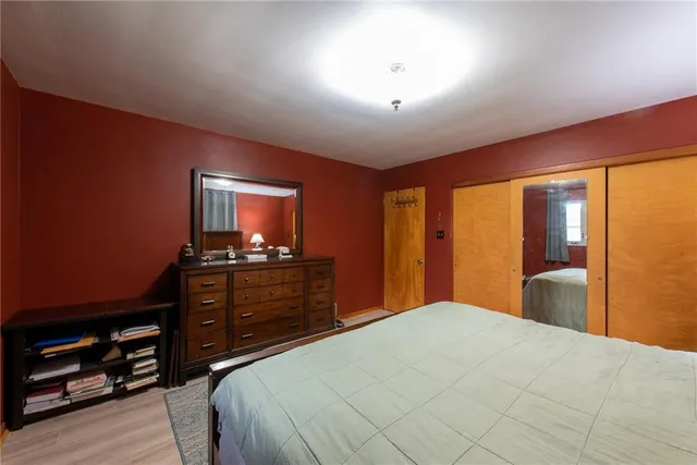 a bedroom with a bed and a dresser