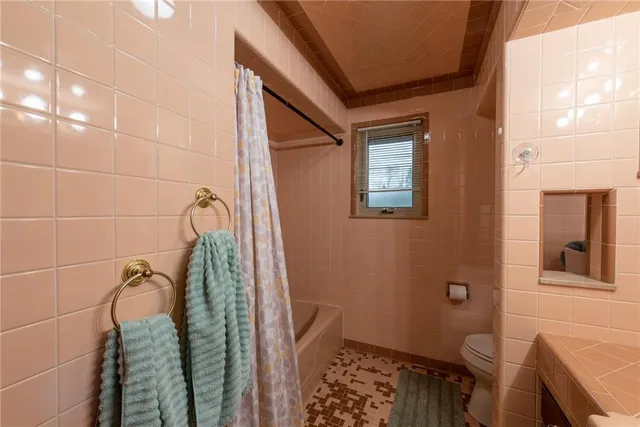 a bathroom with a bathtub and shower