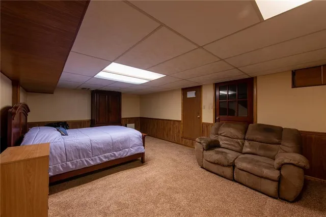 a bedroom with bed couch and window