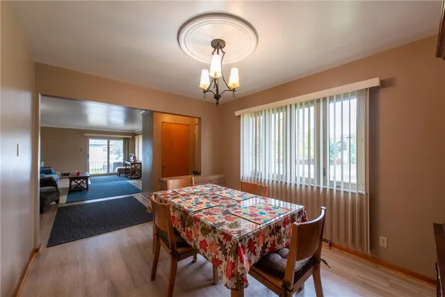 a dining room with a table chairs and a chandelier