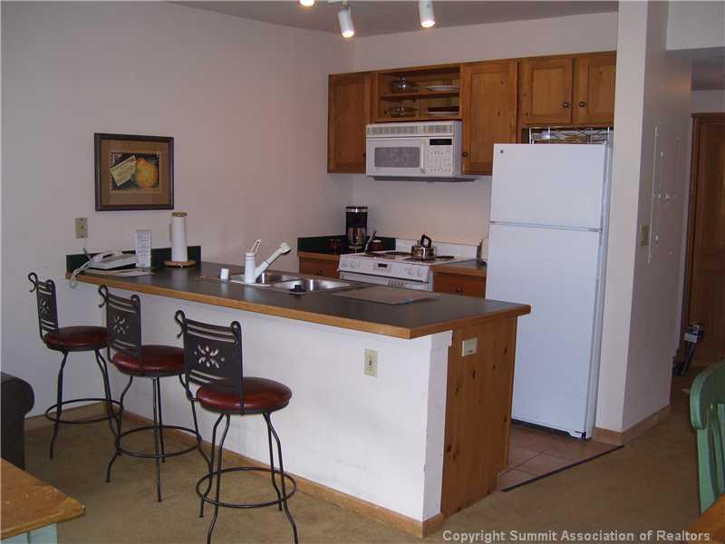 195 River Run Road, Unit 8012 Keystone, CO 80435 - Photo 7 of 19 a kitchen with stainless steel appliances a stove a refrigerator and a refrigerator