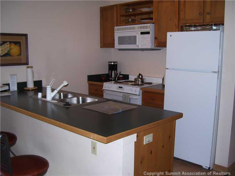195 River Run Road, Unit 8012 Keystone, CO 80435 - Photo 8 of 19 a kitchen with a sink a stove and refrigerator