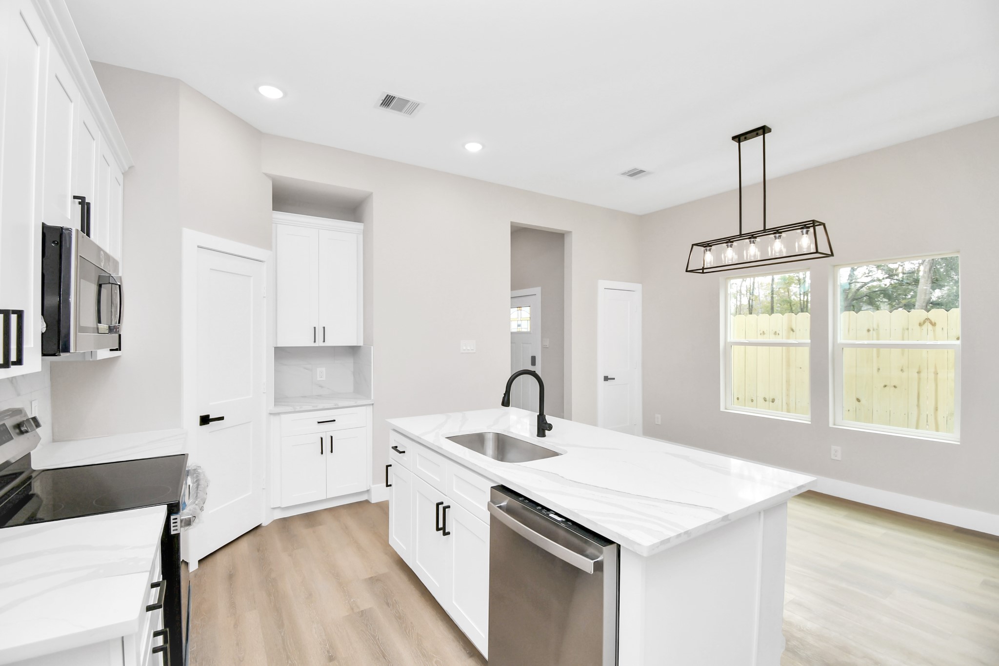 8409 Sunnyhill Street Houston, TX 77088 - Photo 4 of 13 a kitchen with a sink stove and cabinets