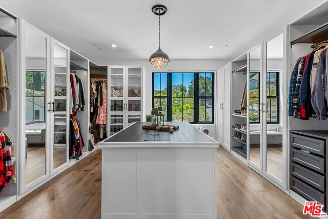 a dining room with furniture floor to ceiling window and entryway