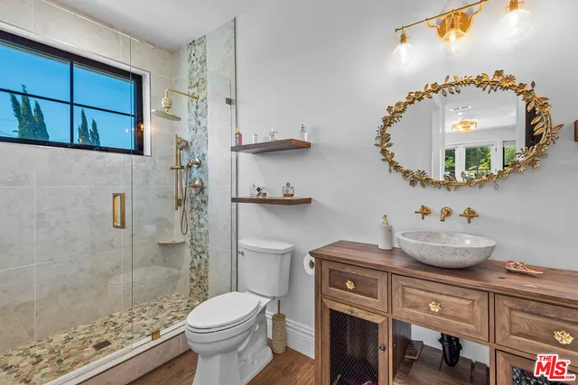 a bathroom with a toilet sink and mirror