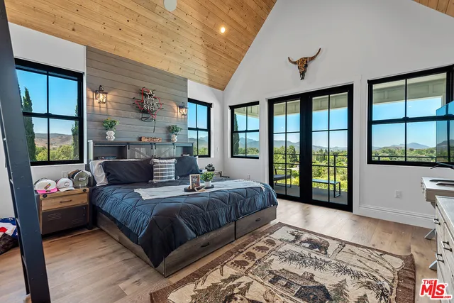 a bedroom with a large bed and a large window