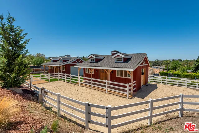 a view of a house with wooden fence