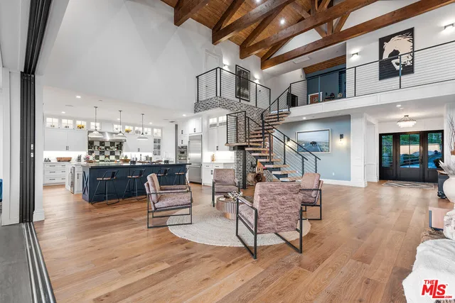 a living room with furniture and kitchen view