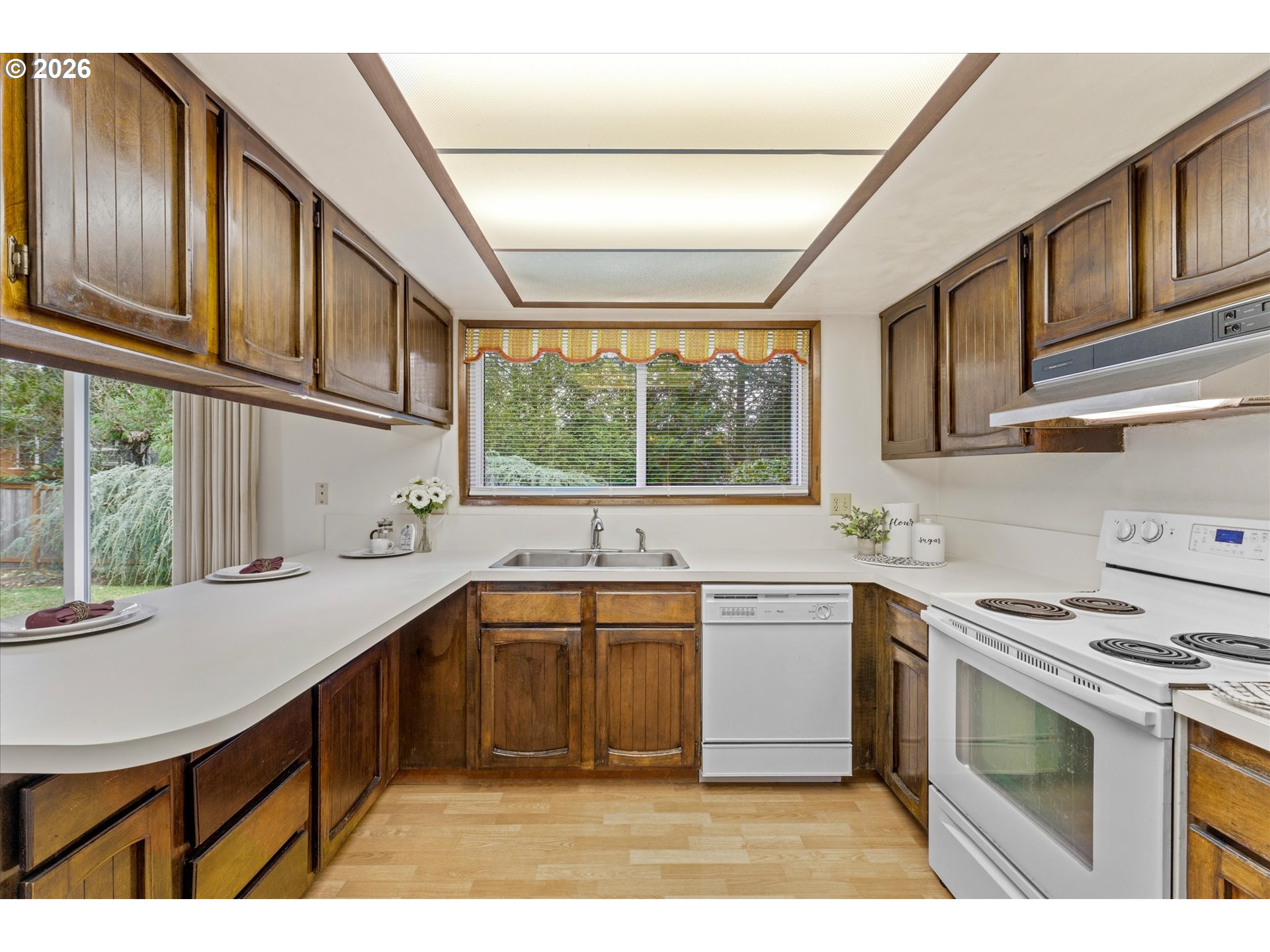 6740 Southwest Hyland Way Beaverton, OR 97008 - Photo 12 of 38 a kitchen with a sink stove and cabinets