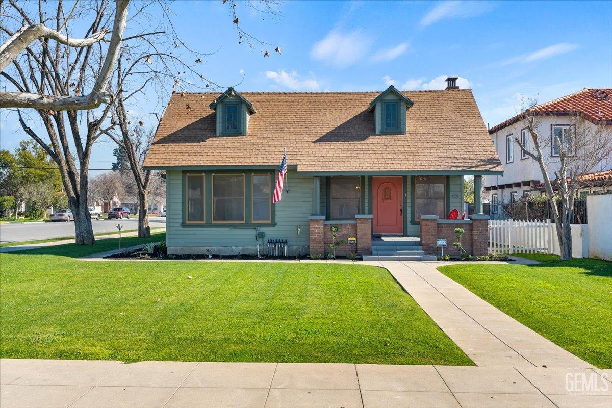 a patio with a table and chairs and a fire pit