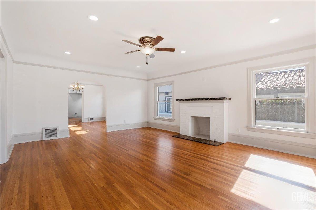 Undisclosed Address Bakersfield, CA 93305 - Photo 11 of 49 a view of a livingroom with wooden floor and a fireplace