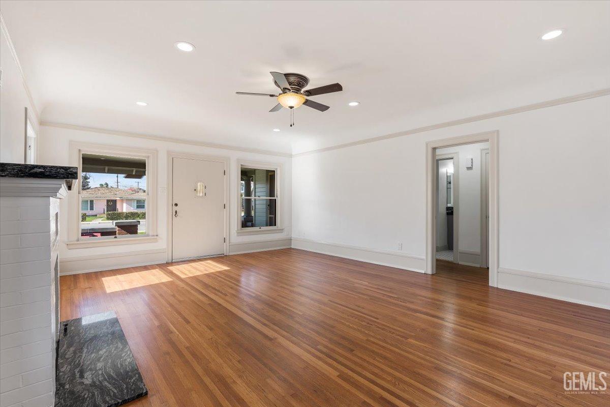 Undisclosed Address Bakersfield, CA 93305 - Photo 12 of 49 a view of an empty room with window and wooden floor