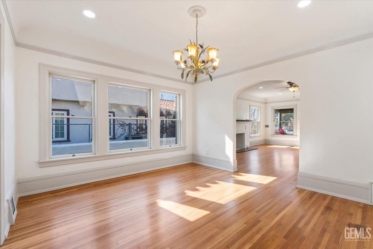Undisclosed Address Bakersfield, CA 93305 - Photo 14 of 49 a view of a room with wooden floor and chandelier