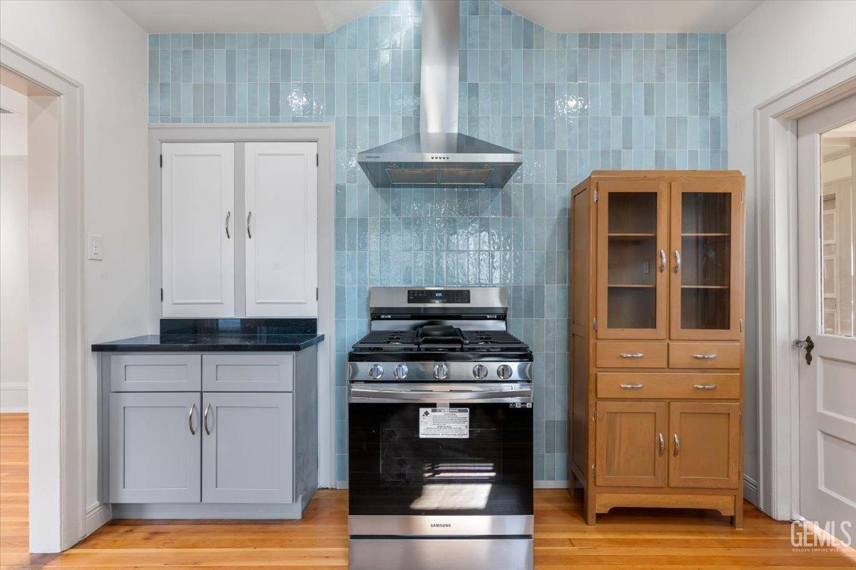 Undisclosed Address Bakersfield, CA 93305 - Photo 18 of 49 a kitchen with granite countertop a stove and a wooden floors